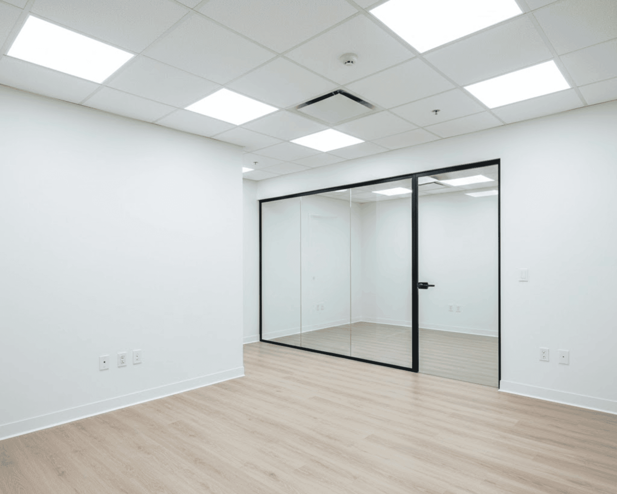 Modern commercial office buildout with glass partition wall